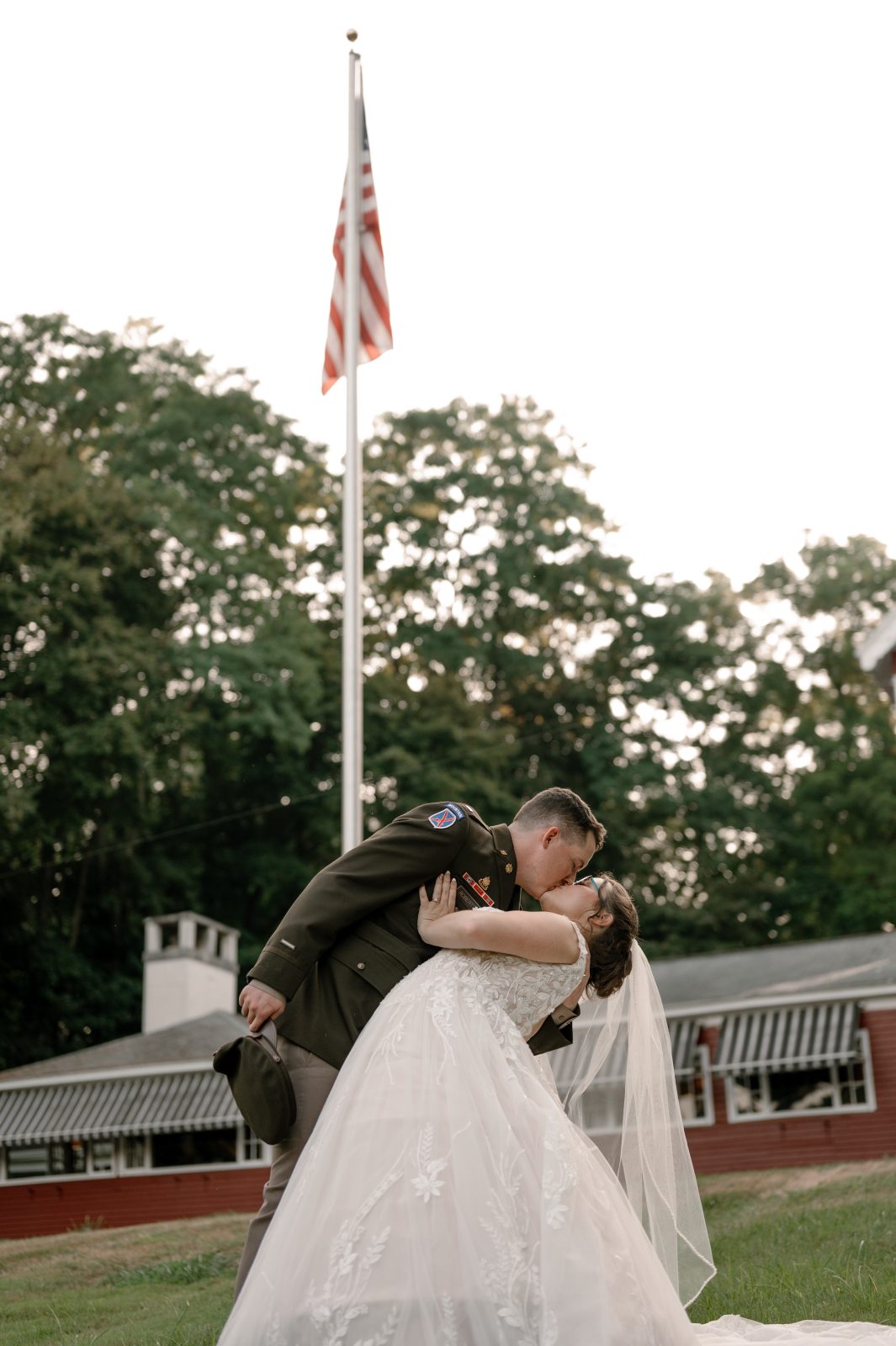 Bride and groom kissing on the front lawns of the Springside Inn Wedding Venue in Central New York