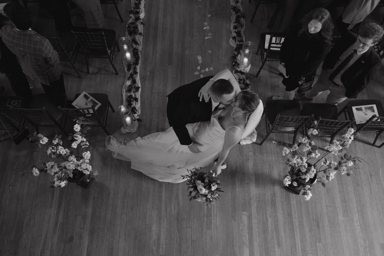 Bride and groom kissing at the end of the aisle at their wedding ceremony in auburn new york