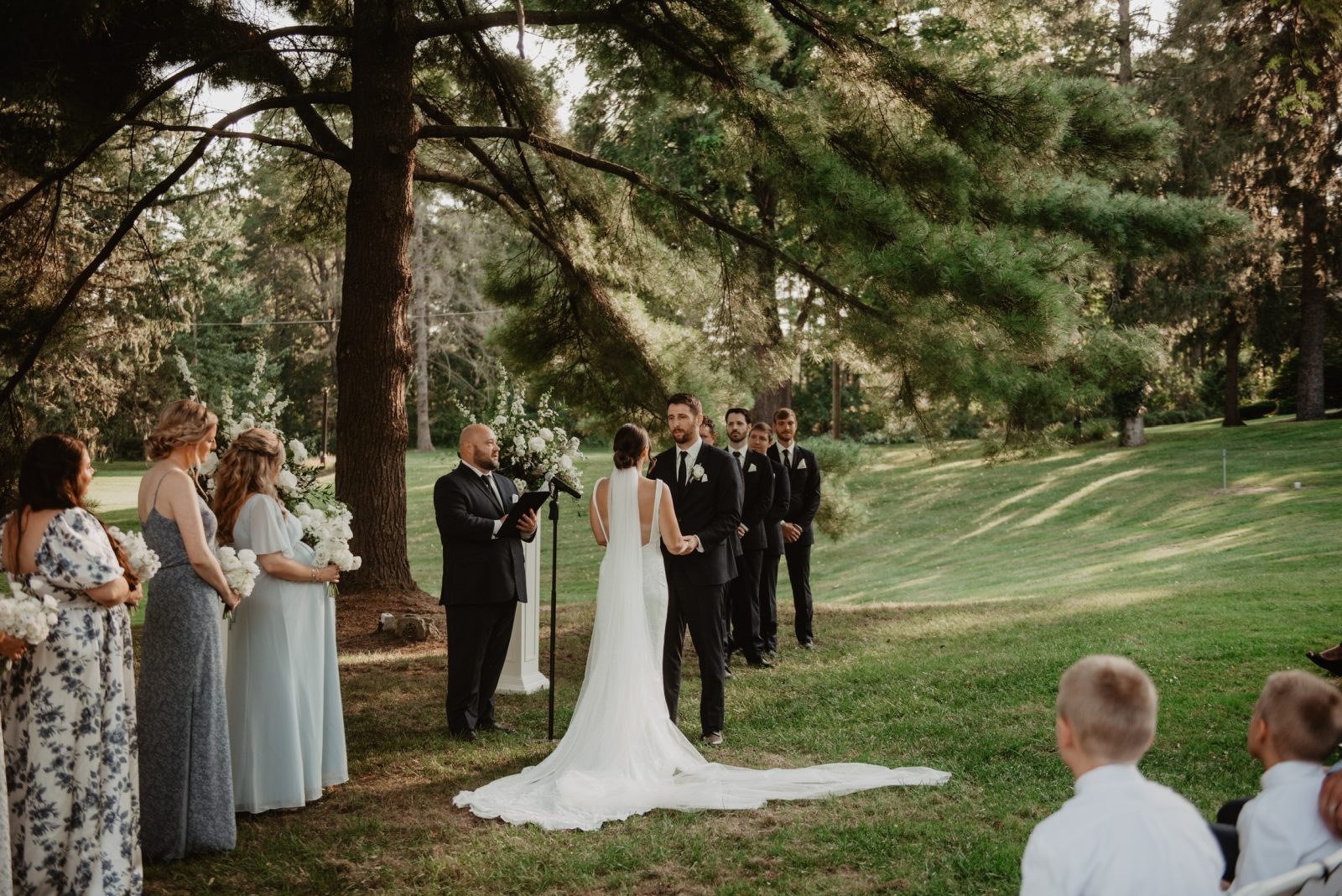 bride and groom wedding ceremony in front of the pond at springside Inn