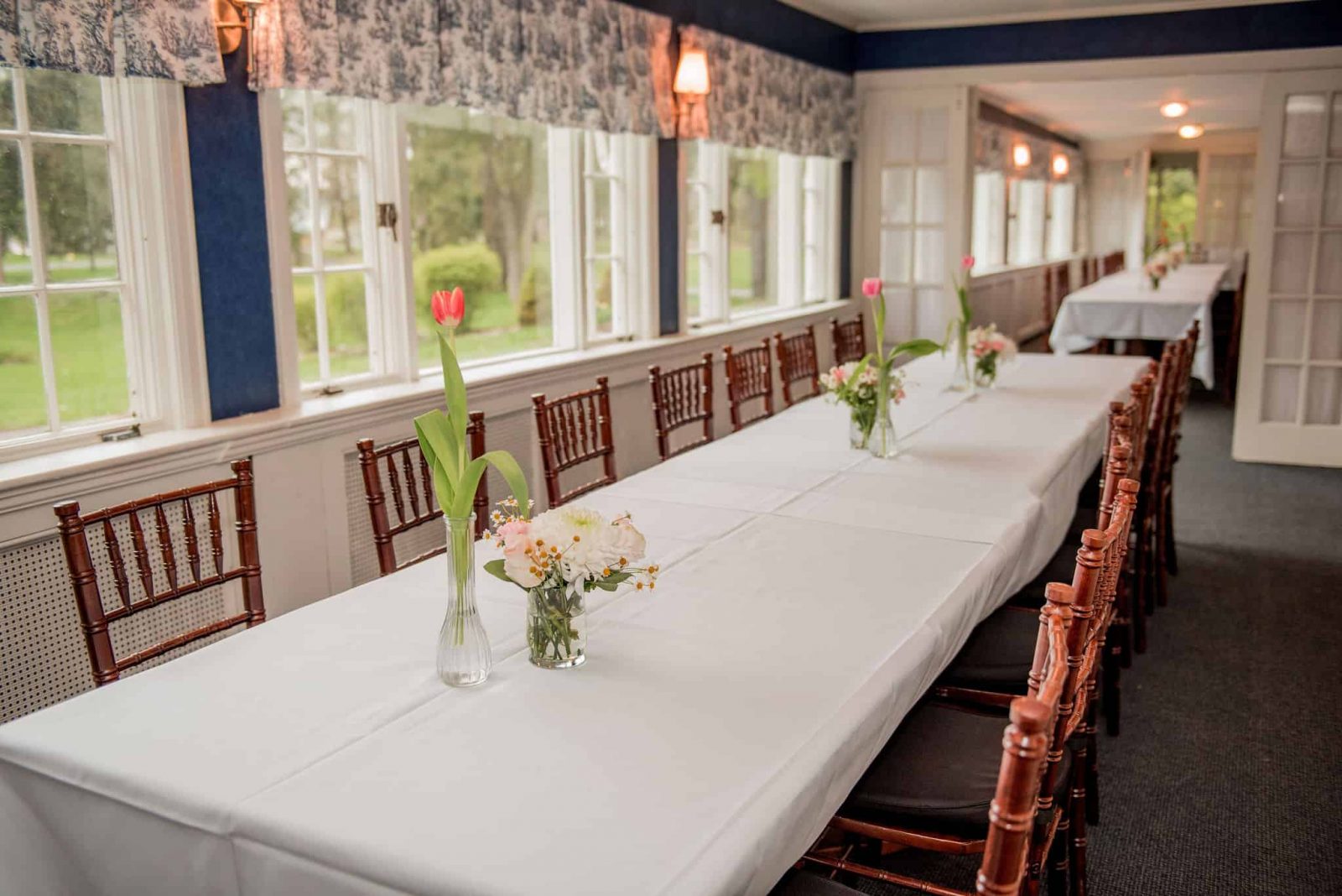 A dining table and windows in the quaint and intimate porches