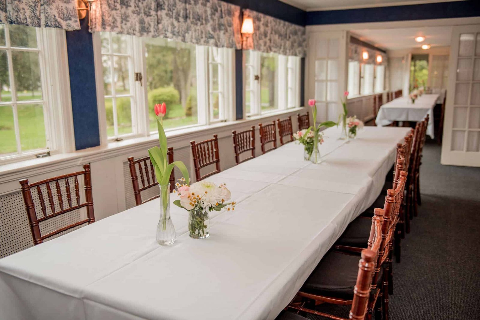 A dining table and windows in the quaint and intimate porches at Springside Inn